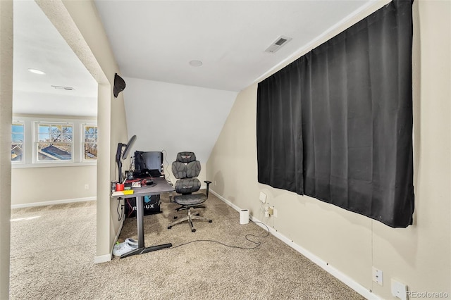 carpeted home office with visible vents, baseboards, and vaulted ceiling