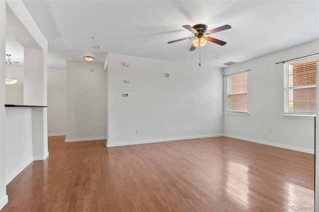 4100 Albion St Unit 614, Denver, CO 80216 - empty room with light wood-style flooring, a ceiling fan, and baseboards