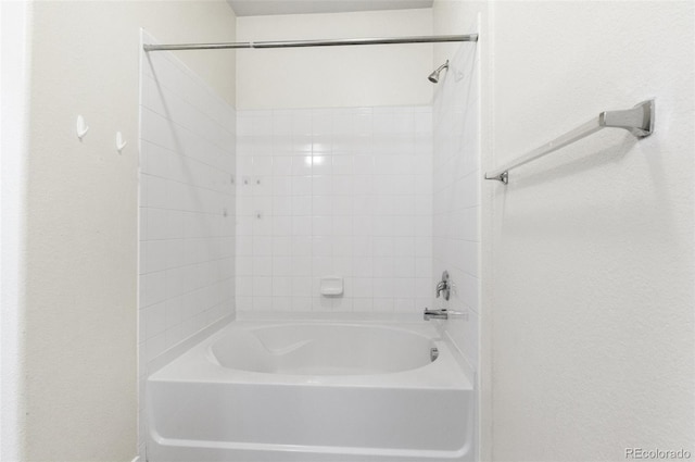 4100 Albion St Unit 614, Denver, CO 80216 - bathroom featuring  shower combination and a textured wall