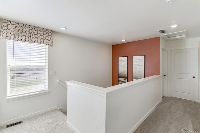 hallway with light colored carpet