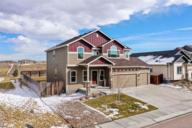 view of front facade with a garage, fence, board and batten siding, and concrete driveway