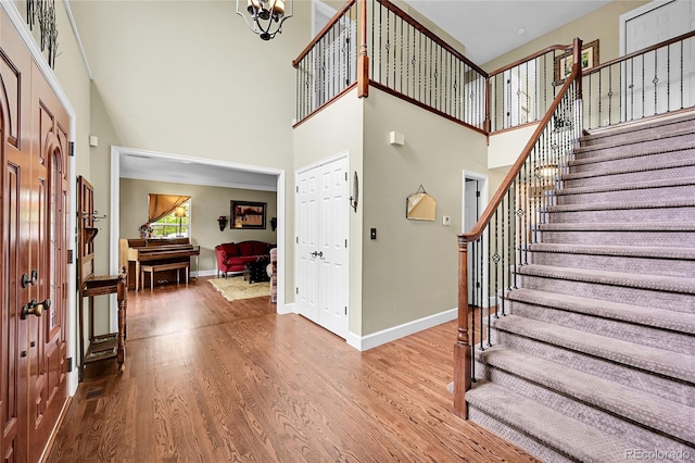 1583 Sunset Ridge Rd, Highlands Ranch, CO 80126 - foyer featuring a high ceiling, stairs, wood finished floors, and baseboards