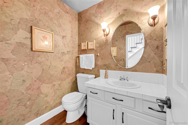 1583 Sunset Ridge Rd, Highlands Ranch, CO 80126 - half bath with vanity, toilet, and wood finished floors