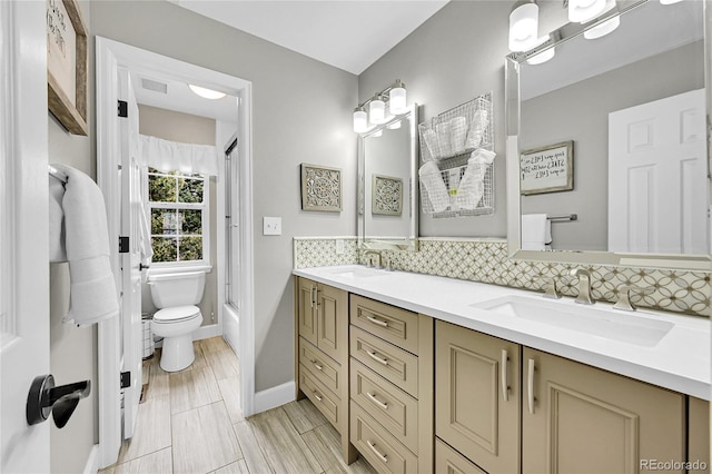 1583 Sunset Ridge Rd, Highlands Ranch, CO 80126 - bathroom featuring toilet, double vanity, backsplash, shower / bathtub combination, and baseboards