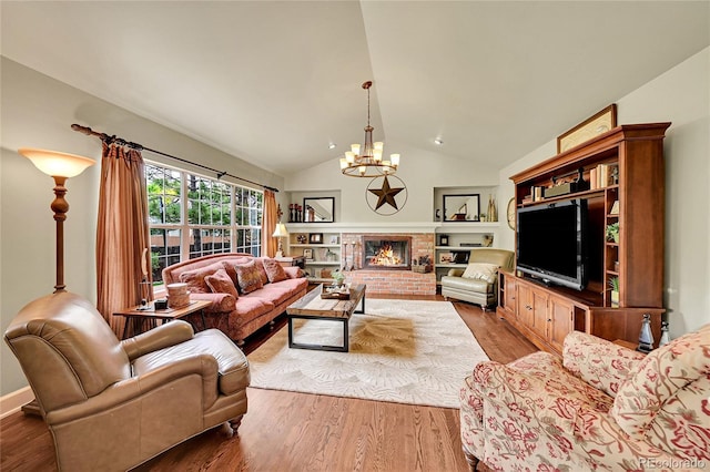 1583 Sunset Ridge Rd, Highlands Ranch, CO 80126 - living room with a chandelier, wood finished floors, lofted ceiling, and a fireplace