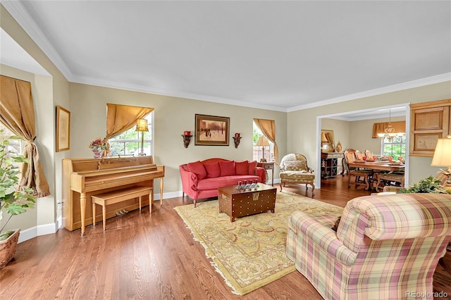 1583 Sunset Ridge Rd, Highlands Ranch, CO 80126 - living area featuring plenty of natural light, a chandelier, ornamental molding, wood finished floors, and baseboards