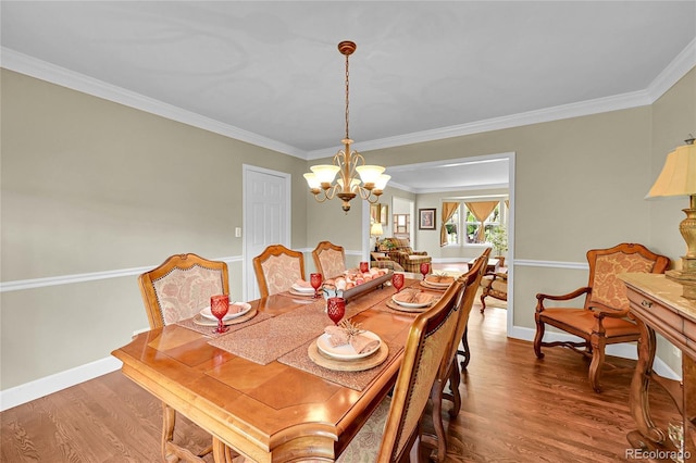 1583 Sunset Ridge Rd, Highlands Ranch, CO 80126 - dining space featuring a chandelier, wood finished floors, ornamental molding, and baseboards
