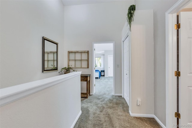 corridor with carpet and baseboards