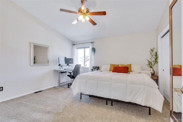 bedroom with carpet floors, vaulted ceiling, an office area, baseboards, and a ceiling fan