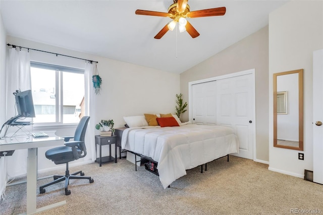 bedroom featuring lofted ceiling, carpet, an office area, a closet, and baseboards
