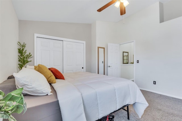 carpeted bedroom featuring a closet, ceiling fan, baseboards, and lofted ceiling