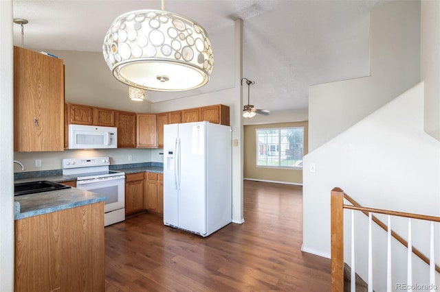 kitchen featuring white appliances, baseboards, ceiling fan, dark wood-type flooring, and a sink