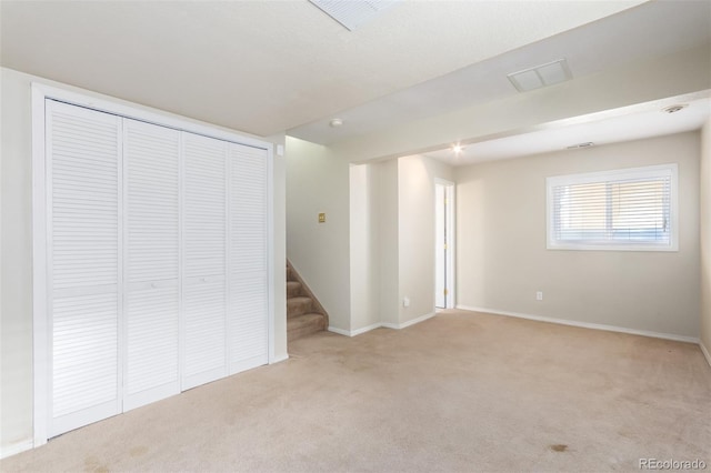 interior space featuring stairway, carpet, and baseboards