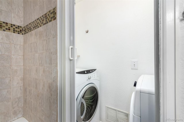 washroom with washer / dryer, laundry area, and visible vents