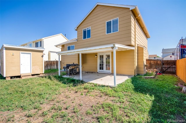 back of property with a patio, french doors, an outdoor structure, and a fenced backyard