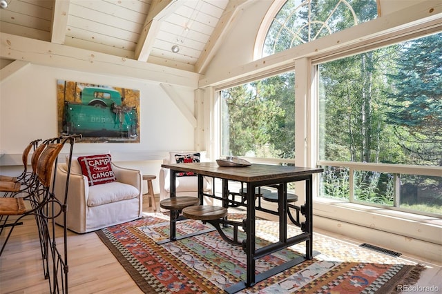 interior space with light wood-type flooring, vaulted ceiling with beams, and wooden ceiling