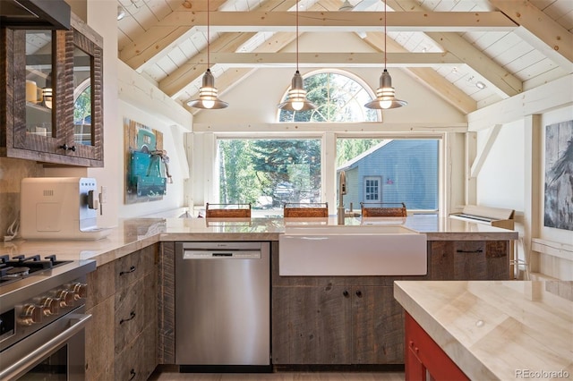 kitchen featuring vaulted ceiling with beams, appliances with stainless steel finishes, hanging light fixtures, and sink