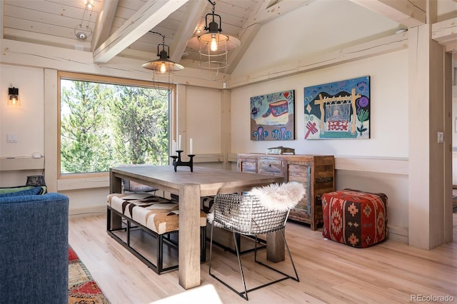 dining area with wood ceiling, vaulted ceiling with beams, and light hardwood / wood-style floors