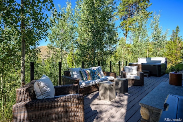 wooden terrace featuring a hot tub and an outdoor hangout area