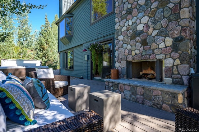 wooden deck featuring an outdoor living space with a fireplace