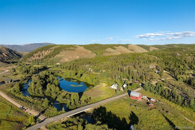 drone / aerial view with a water and mountain view