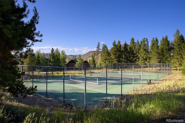 view of tennis court with a mountain view