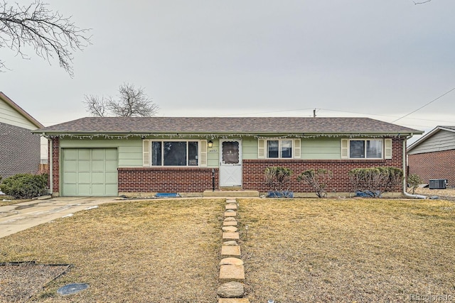 ranch-style home with a front yard, concrete driveway, and brick siding