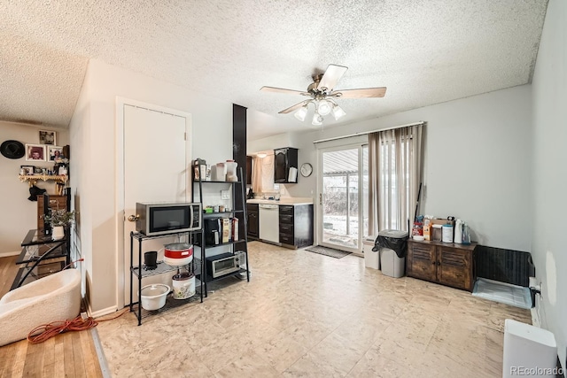 interior space with a textured ceiling, a ceiling fan, and baseboards