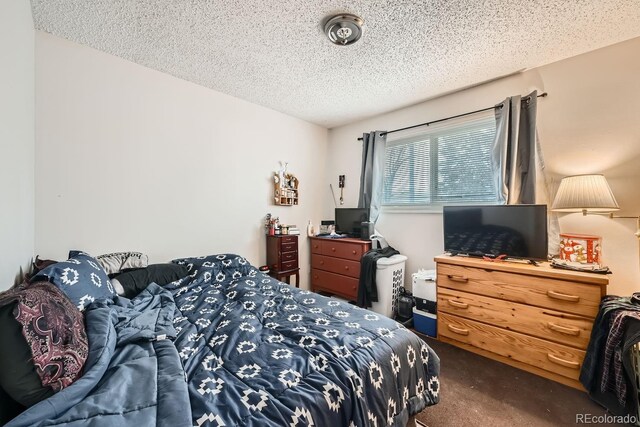 carpeted bedroom featuring a textured ceiling