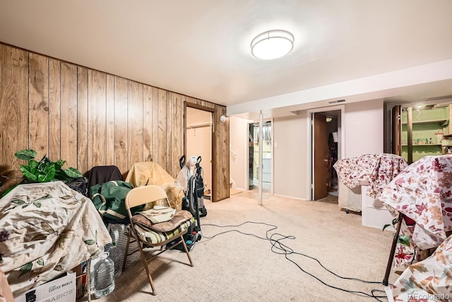 interior space with visible vents, light colored carpet, and wooden walls