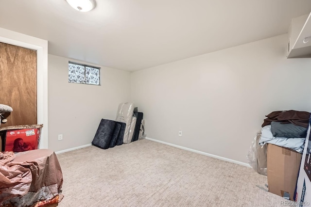 interior space featuring baseboards and light colored carpet