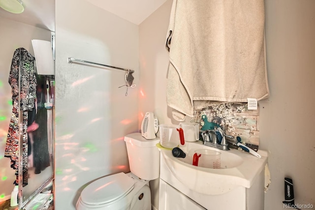 bathroom featuring toilet and vanity