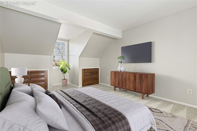 carpeted bedroom with lofted ceiling