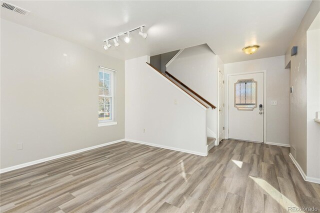 foyer entrance featuring light wood-type flooring and track lighting