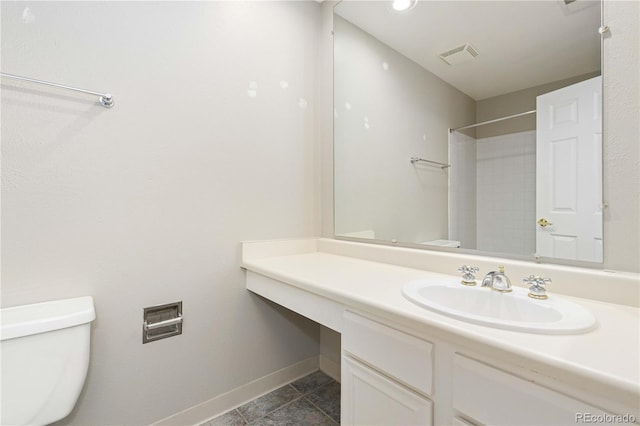 bathroom featuring toilet, vanity, and tile patterned floors