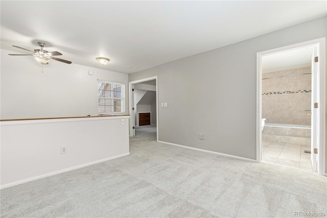 carpeted spare room with ceiling fan