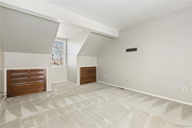 additional living space featuring carpet and lofted ceiling with beams