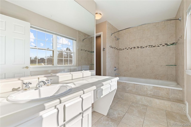 bathroom featuring tile patterned floors, vanity, and tiled shower / bath