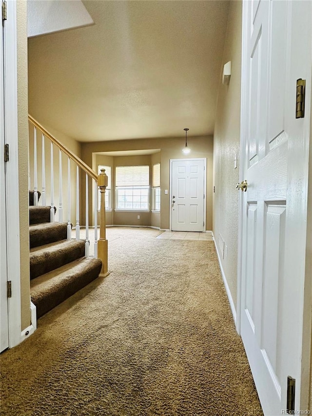 6102 S Yampa St, Aurora, CO 80016 - carpeted foyer entrance featuring stairs and baseboards