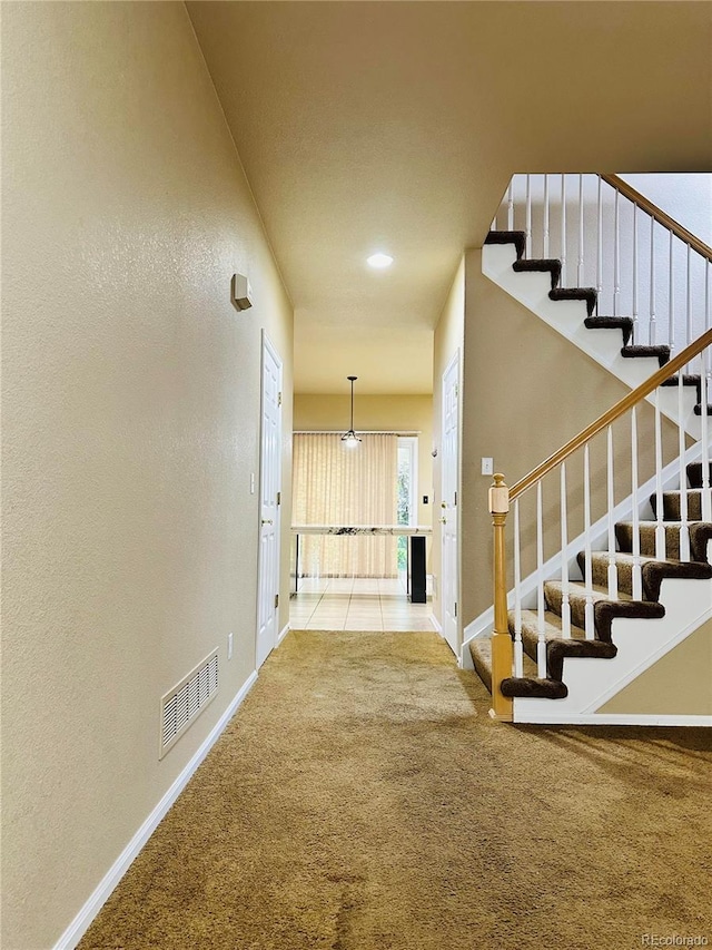 6102 S Yampa St, Aurora, CO 80016 - corridor with carpet floors, stairs, and a textured wall