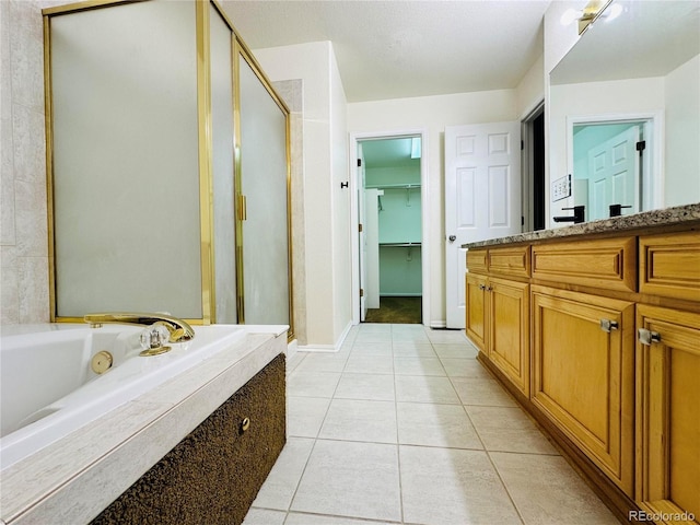 6102 S Yampa St, Aurora, CO 80016 - full bathroom featuring a shower stall, vanity, a jetted tub, and tile patterned floors