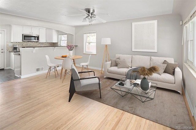 1856 S Monroe St, Denver, CO 80210 - living area with wood finished floors and ceiling fan
