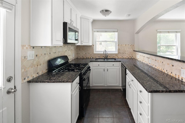 1856 S Monroe St, Denver, CO 80210 - kitchen with black appliances, healthy amount of natural light, white cabinetry, and tasteful backsplash