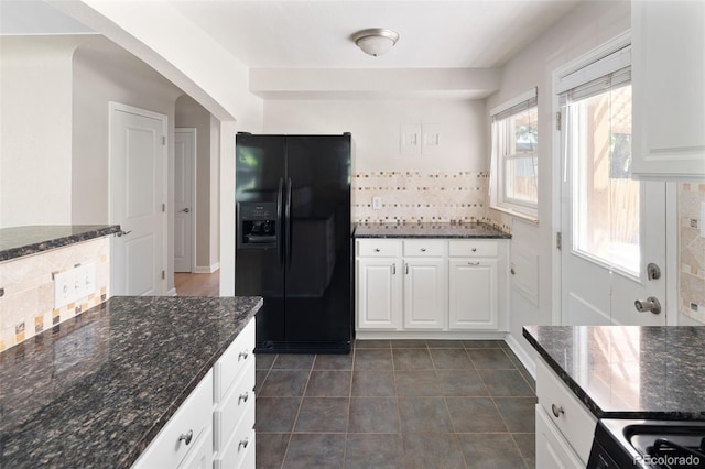 1856 S Monroe St, Denver, CO 80210 - kitchen with black fridge with ice dispenser, tasteful backsplash, white cabinets, arched walkways, and dark stone counters