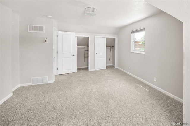1856 S Monroe St, Denver, CO 80210 - unfurnished bedroom featuring carpet floors and multiple closets