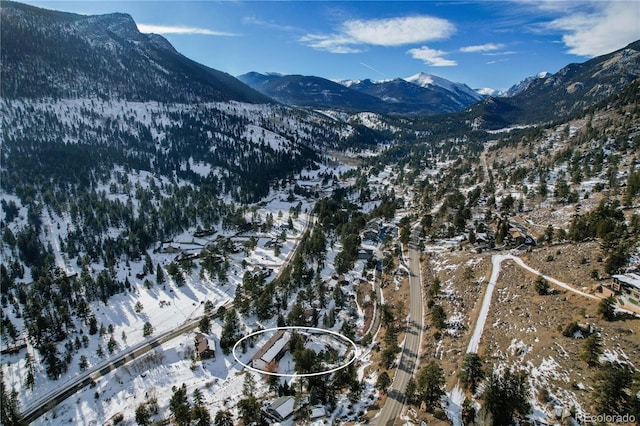 snowy aerial view with a mountain view