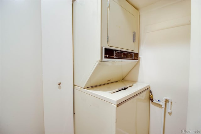 washroom featuring laundry area and stacked washer / drying machine