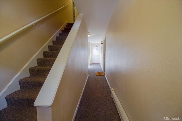 stairway featuring carpet flooring and baseboards