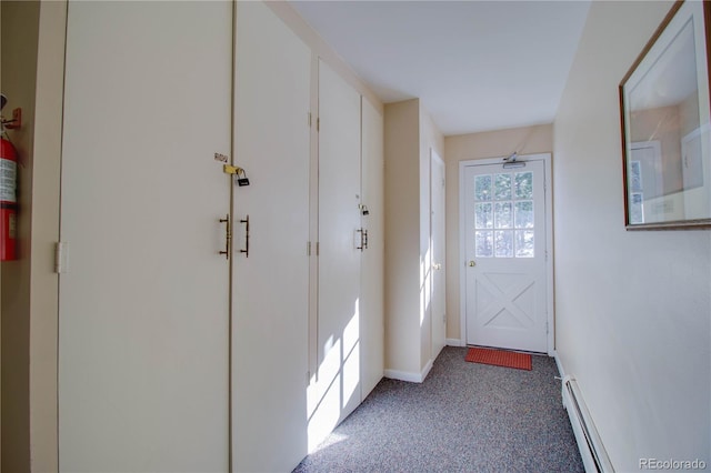 doorway to outside with a baseboard heating unit, carpet floors, and baseboards