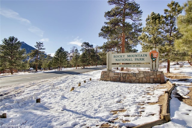 community sign with a mountain view